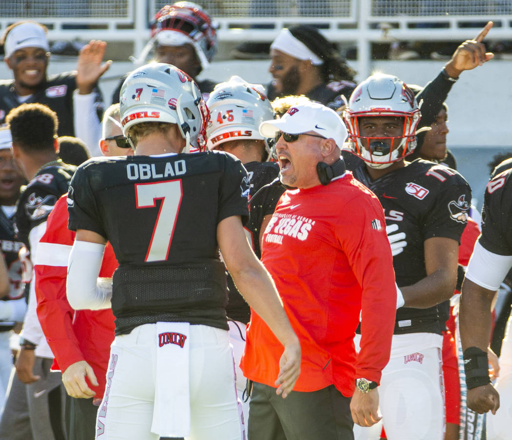 UNLV Rebels quarterback Kenyon Oblad (7) is congratulated on another touchdown by UNLV Rebels h ...