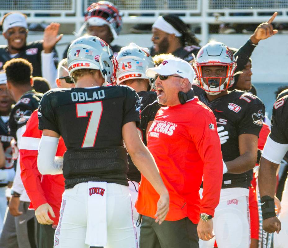 UNLV Rebels quarterback Kenyon Oblad (7) is congratulated on another touchdown by UNLV Rebels h ...