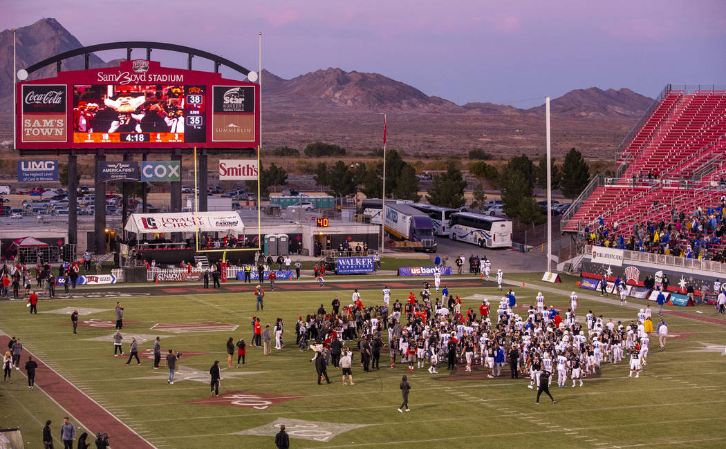 UNLV Rebels and San Jose State Spartans players and coaches come together on the field followin ...