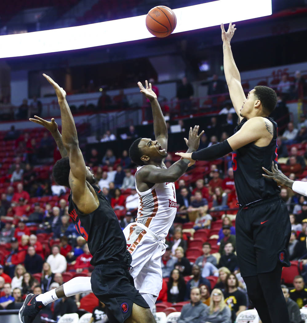 UNLV's Amauri Hardy (3) loses possession of the ball between Southern Methodist's Isiaha Mike, ...