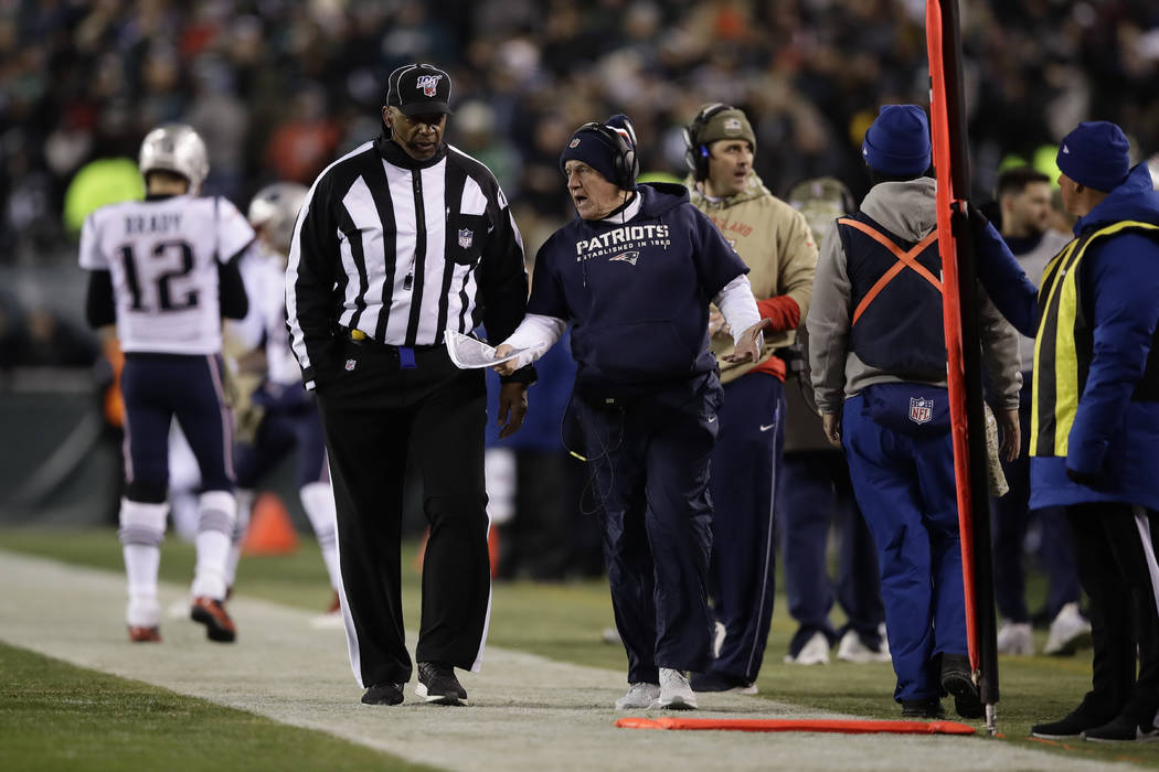 New England Patriots head coach Bill Belichick talks with an official during the first half of ...