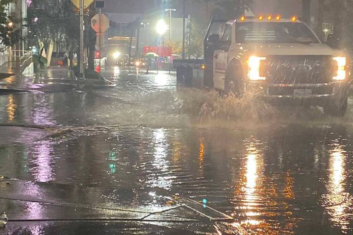 A truck runs through standing water on Linq Lane and Flamingo Road near the Las Vegas Strip, We ...