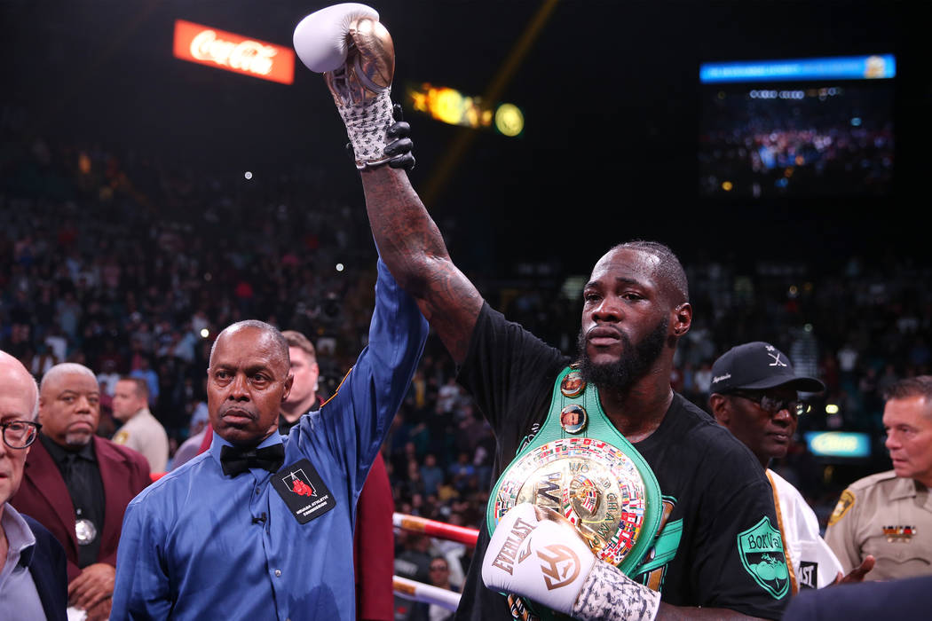 Referee Kenny Bayless raises the hand of Deontay Wilder after knocking out Luis Ortiz during th ...