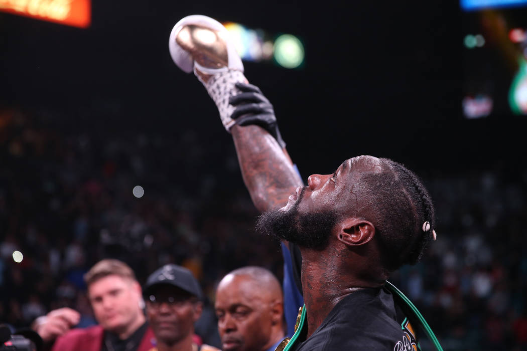 Referee Kenny Bayless raises the hand of Deontay Wilder after knocking out Luis Ortiz during th ...