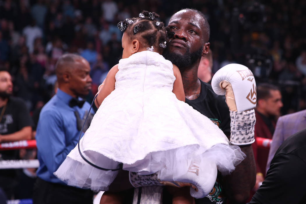 Deontay Wilder holds his 1-year-old daughter Kaorii, 1, after his knockout win against Luis Or ...