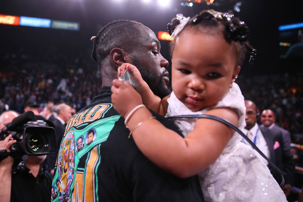 Deontay Wilder holds his 1-year-old daughter Kaorii, 1, after his knockout win against Luis Or ...