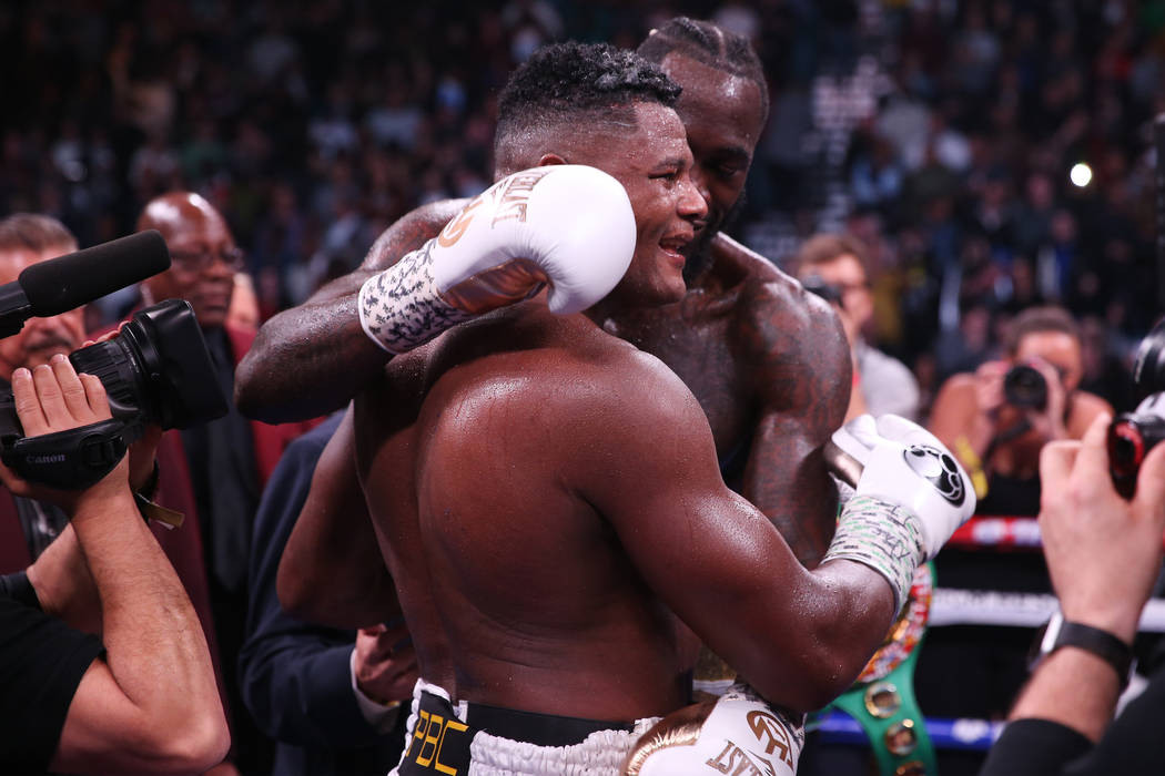 Deontay Wilder, rear, embraces his opponent Luis Ortiz after winning by way of knockout in the ...