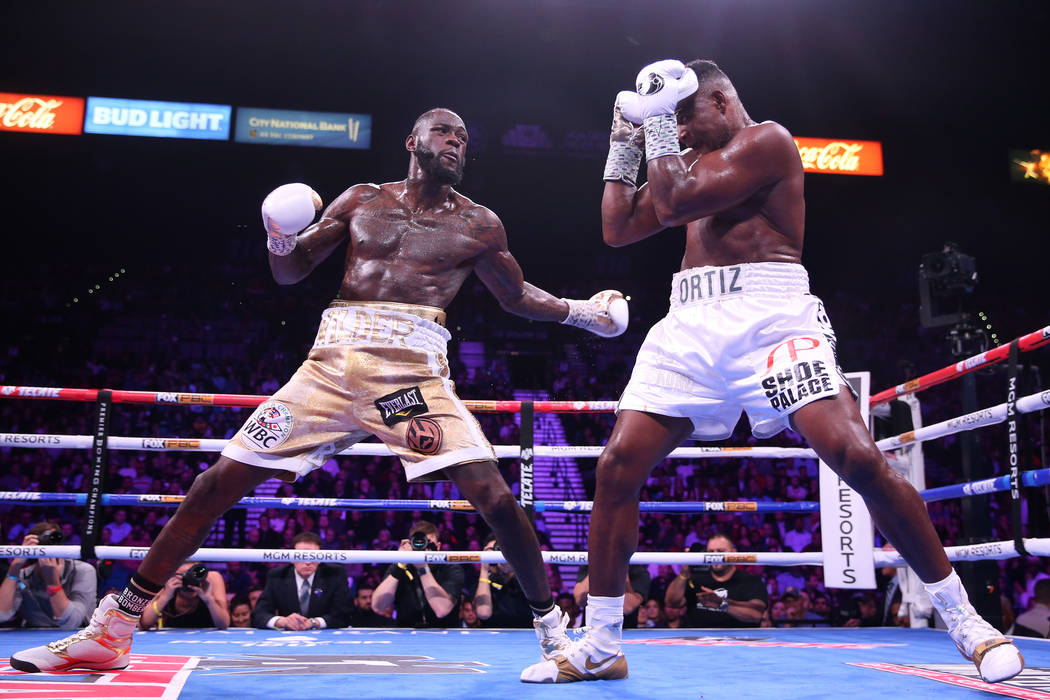 Deontay Wilder, left, battles Luis Ortiz during the seventh round of the WBC heavyweight title ...