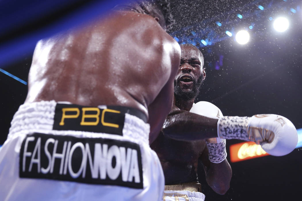 Deontay Wilder, right, knocks out Luis Ortiz during the seventh round of the WBC heavyweight ti ...