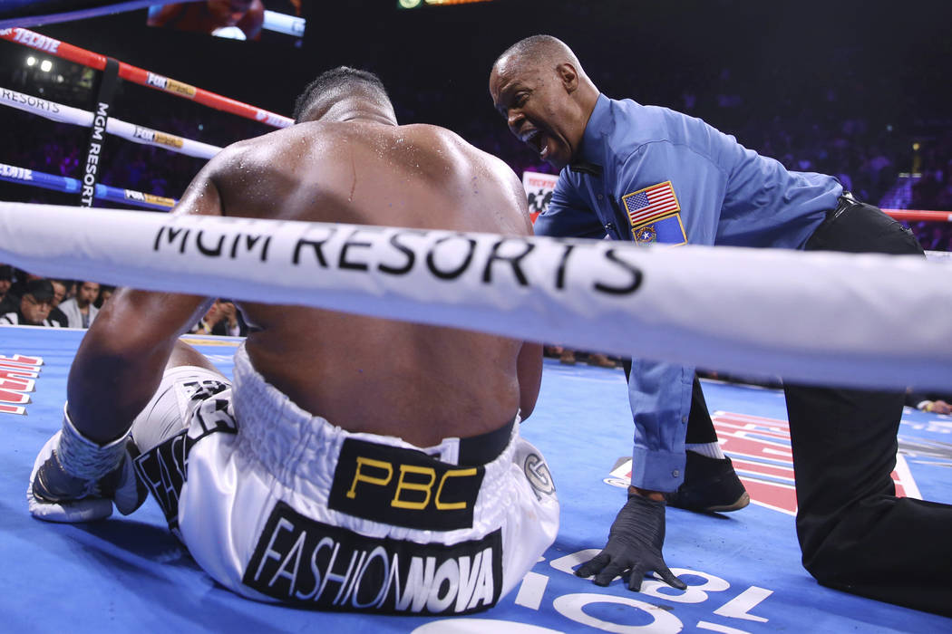 Kenny Bayless gives a countdown to Luis Ortiz after he was knocked down by Deontay Wilder durin ...