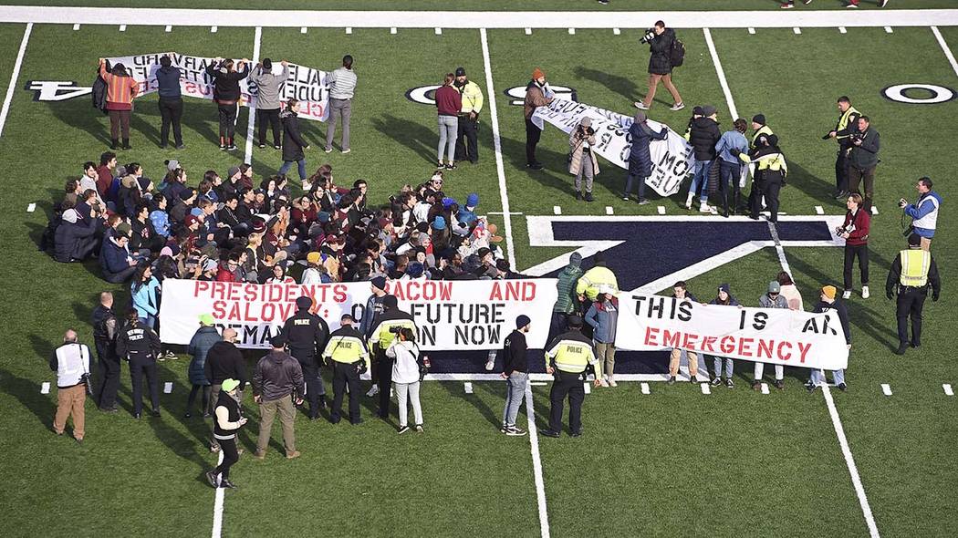 Demonstrators stage a climate change protest at the Yale Bowl delaying the start of the second ...