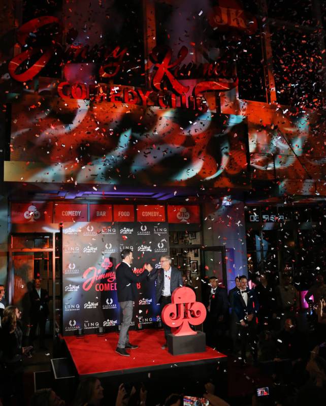 TV host Jimmy Kimmel, left, and Tony Rodio, right, CEO of Caesars Entertainment, high five each ...