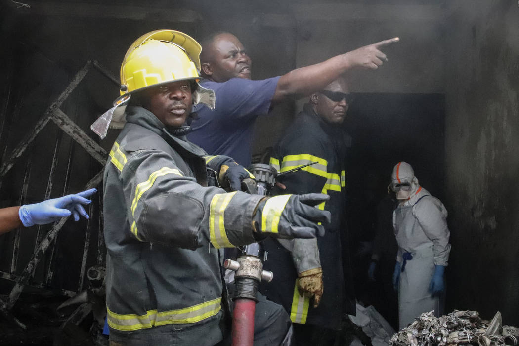 Rescuers attend the scene of an aircraft operated by private carrier Busy Bee which crashed in ...