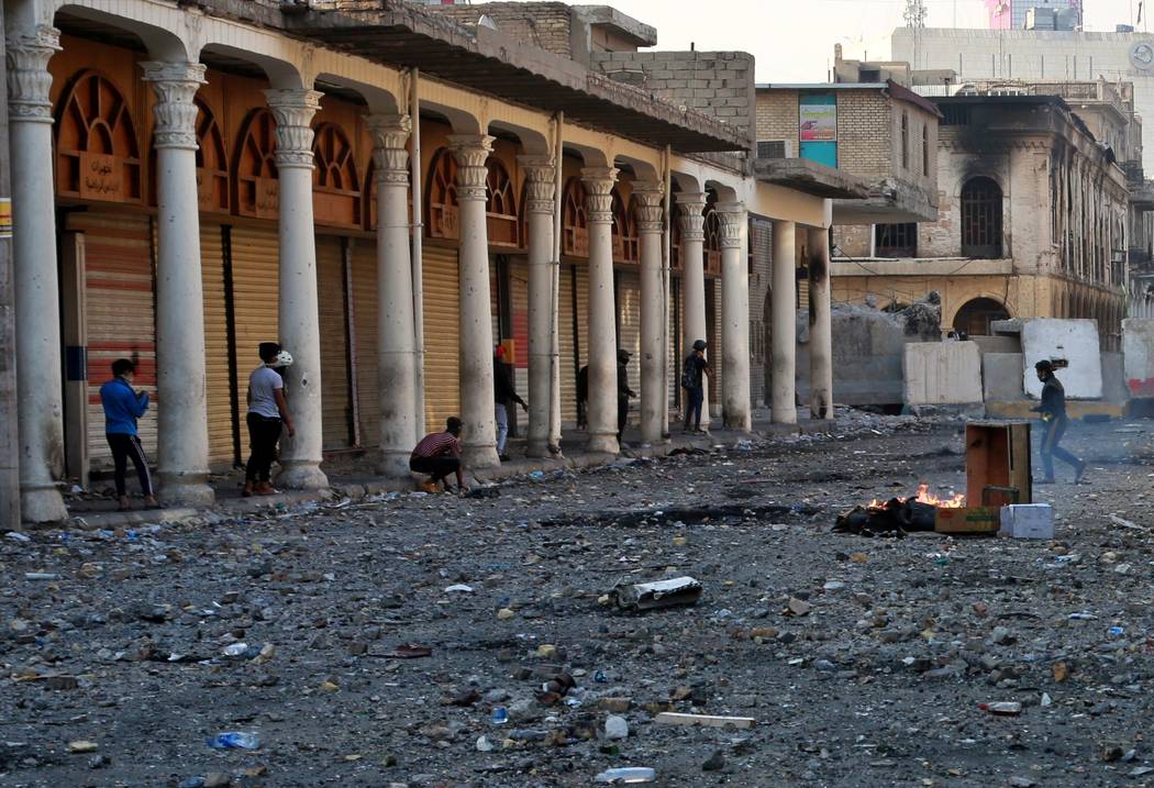 Demonstrators take cover during clashes between security forces and anti-government protesters ...