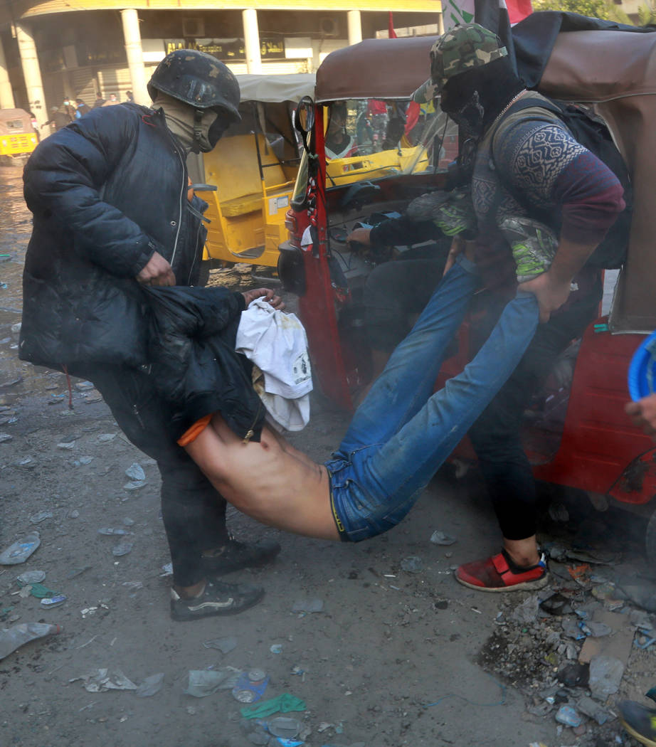 An injured protester is rushed to a hospital during clashes between security forces and anti-go ...