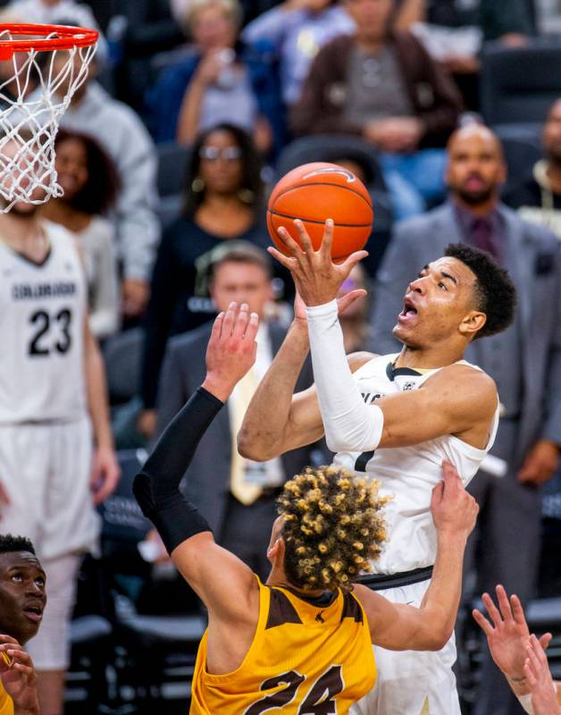 Colorado guard Tyler Bey (1, above) elevates for a shot over Wyoming guard Hunter Maldonado (24 ...