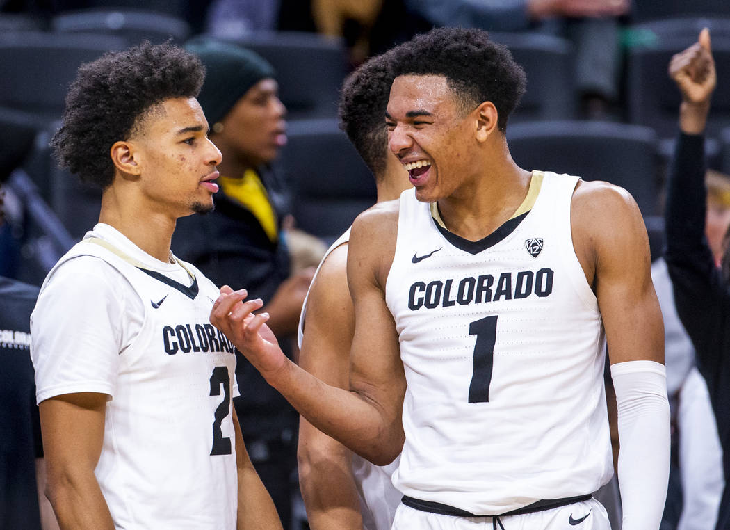 Colorado guard Tyler Bey (1, right) laughs with teammate Daylen Kountz (2) as the game winds do ...