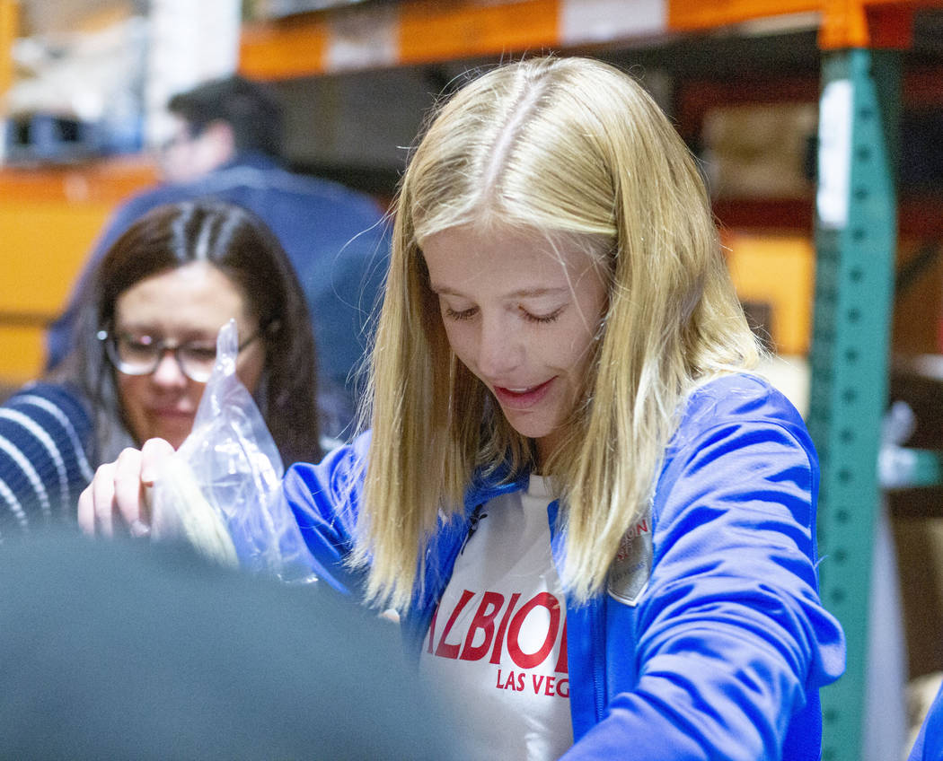 Las Vegas Albion Soccer Club player Lucy Jorjorian, 17, packs assorted foods in preparation fo ...