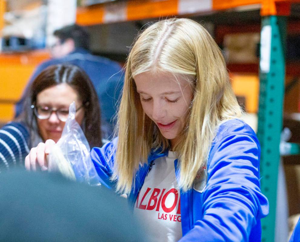 Las Vegas Albion Soccer Club player Lucy Jorjorian, 17, packs assorted foods in preparation fo ...