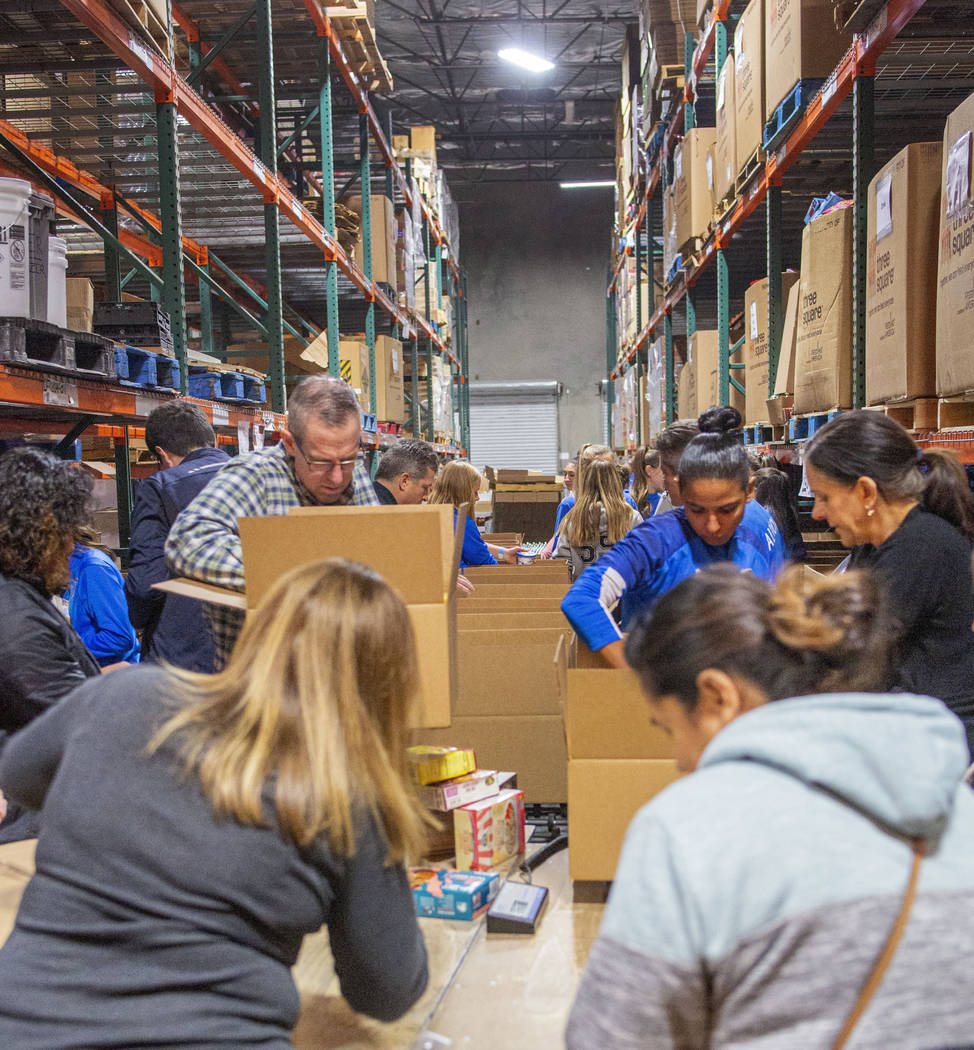 The Las Vegas Albion Soccer Club pack assorted foods in preparation for Thanksgiving at Three S ...