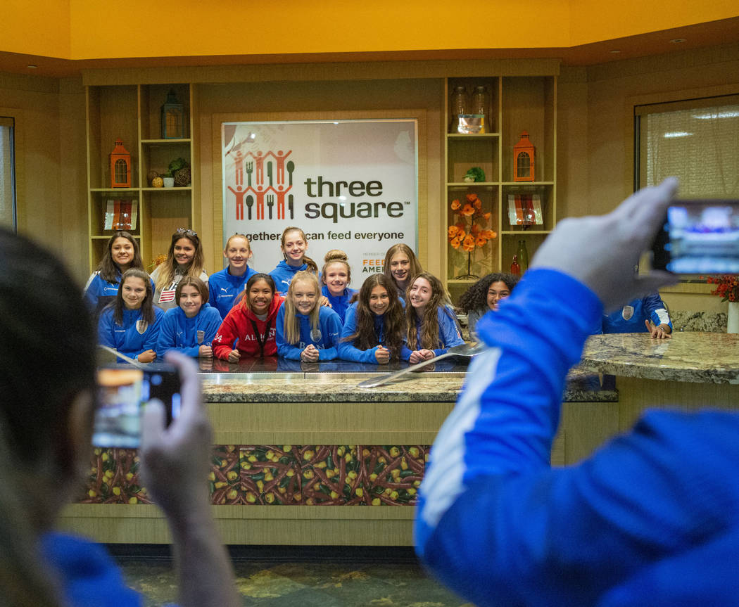 The Las Vegas Albion Soccer Club players take their photo after packing assorted foods in prepa ...