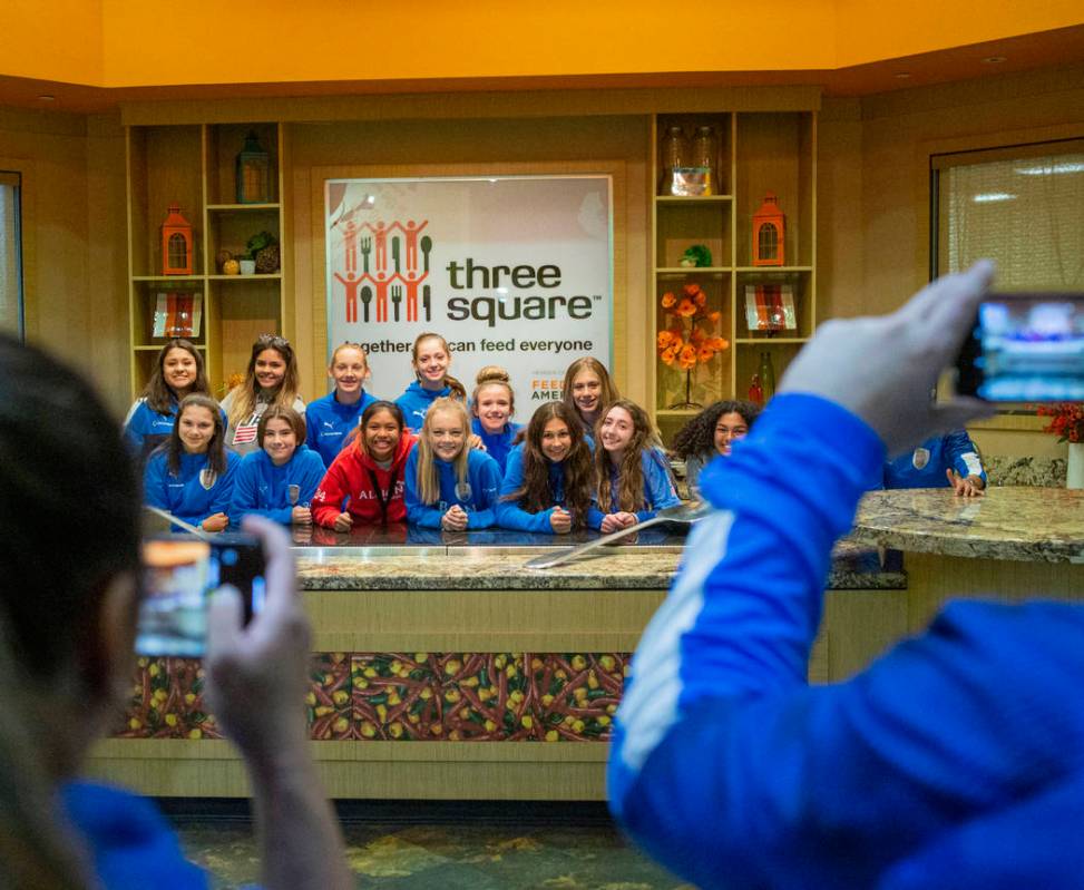 The Las Vegas Albion Soccer Club players take their photo after packing assorted foods in prepa ...