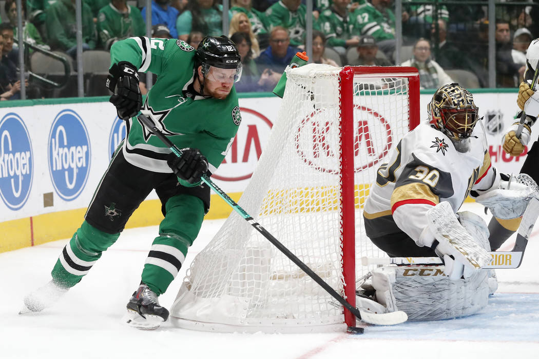 Dallas Stars center Radek Faksa (12) takes a wraparound shot-attempt as Vegas Golden Knights go ...