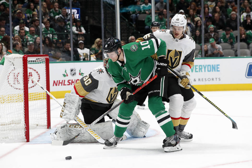 Dallas Stars right wing Corey Perry (10) attempts to gain control of the puck in front of Vegas ...