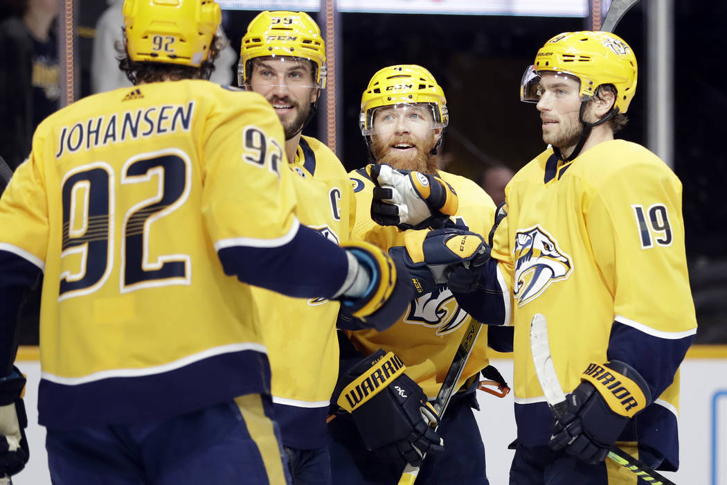 Nashville Predators defenseman Ryan Ellis (4) celebrates with Ryan Johansen (92); Roman Josi (5 ...