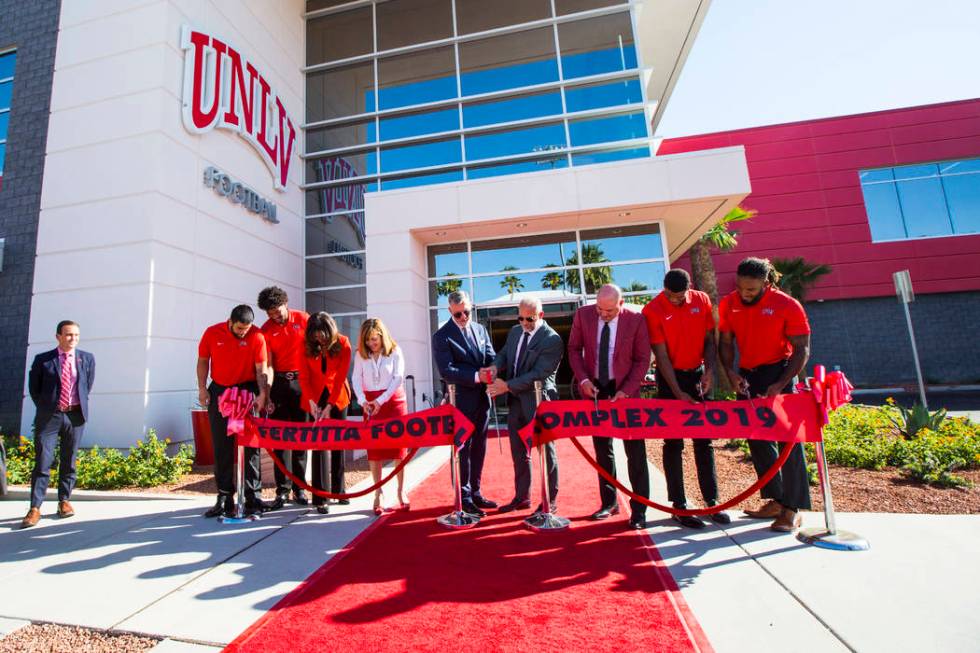 Frank Fertitta III, center left, and Lorenzo Fertitta, center right, are joined by UNLV footbal ...