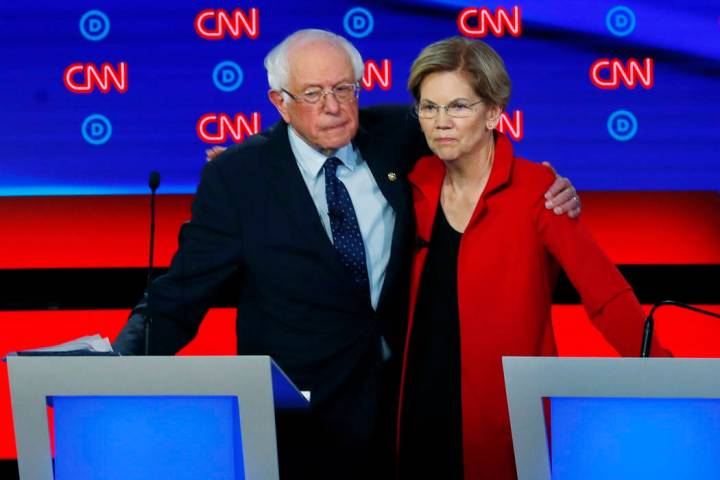 Sen. Bernie Sanders, I-Vt., and Sen. Elizabeth Warren, D-Mass., embrace after the first of two ...