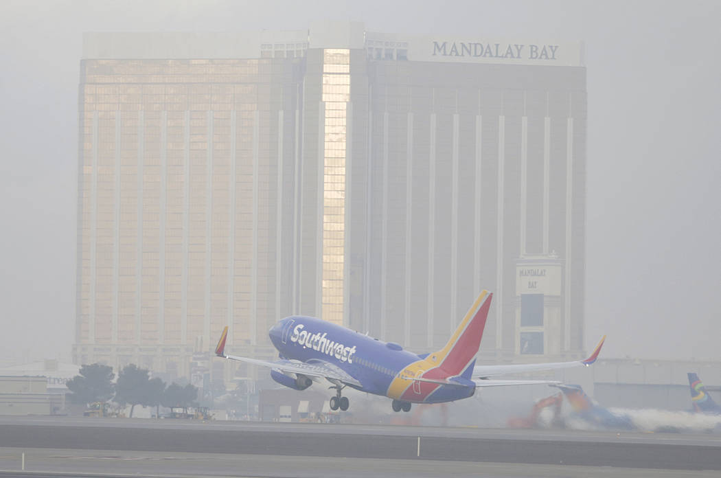 A Southwest Airlines jet takes off in dense fog at McCarran International Airport on Friday, De ...
