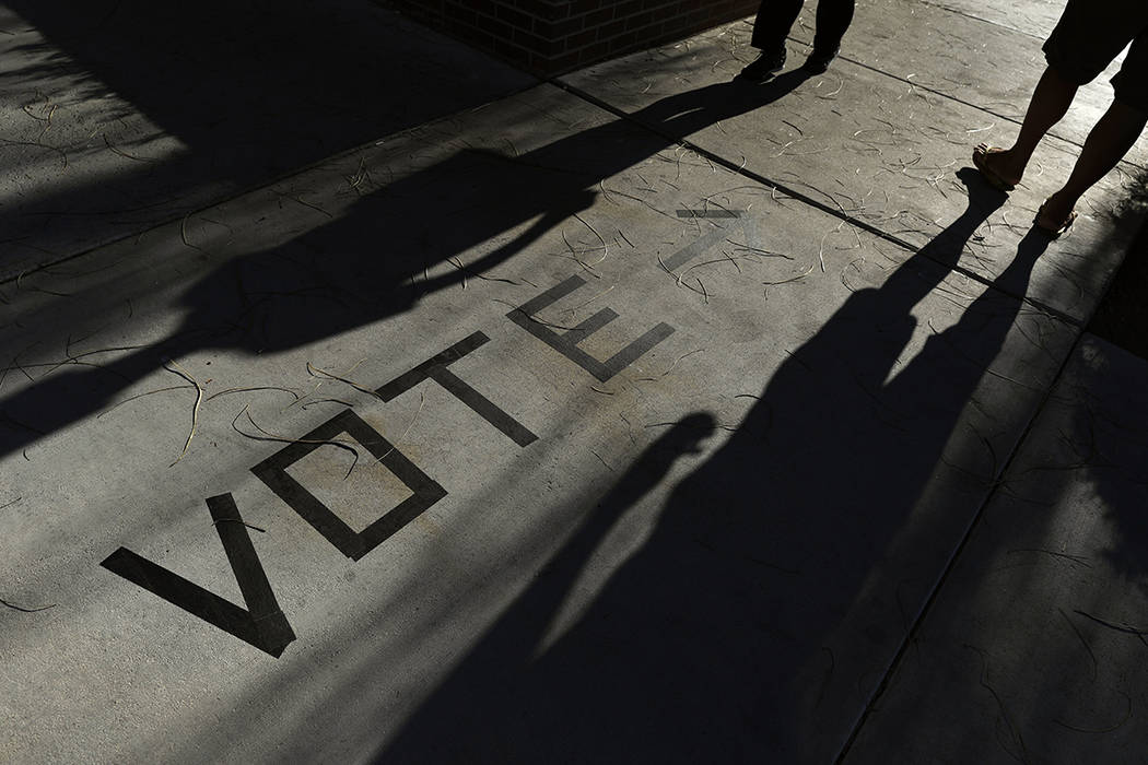 FILE - In this Nov. 6, 2018 file photo, voters head to the polls at the Enterprise Library in L ...