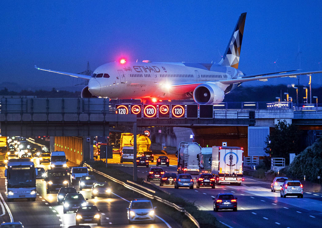 FILE - In this Friday, Sept. 20, 2019 an aircraft crosses a bridge over a highway the airport i ...