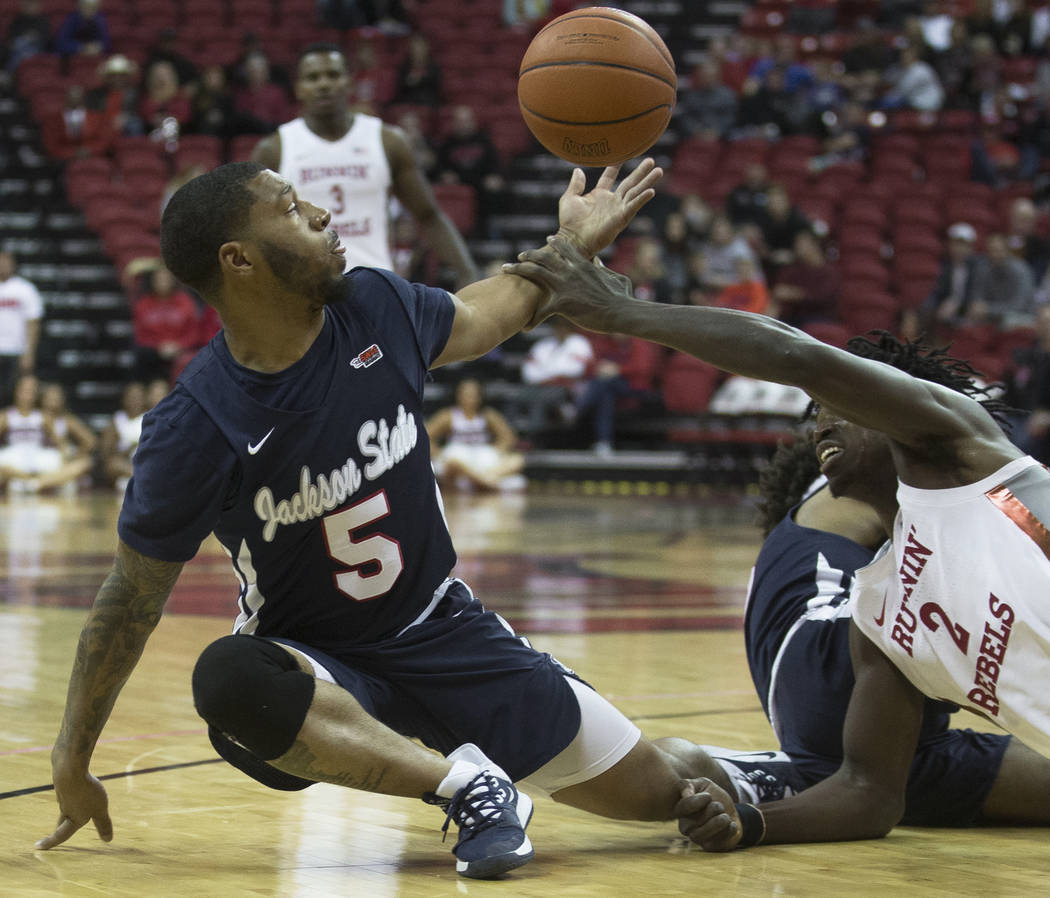 UNLV Rebels forward Donnie Tillman (2) fights for a loose ball with Jackson State Tigers guard ...