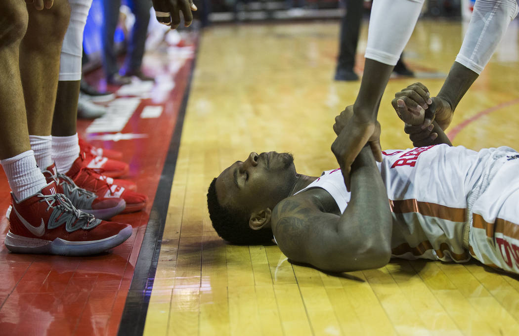 UNLV Rebels guard Amauri Hardy (3) is helped to his feet by a teammate in the second half durin ...