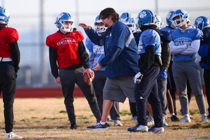 Centennial football coach Dustin Forshee, right, motions in front of quarterback Colton Tenney, ...