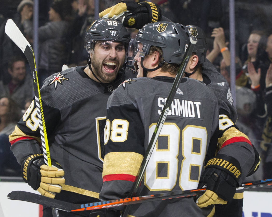 Golden Knights right wing Alex Tuch (89) celebrates with teammate Nate Schmidt (88) after assis ...