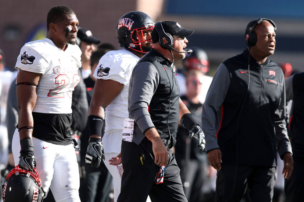 UNLV Rebels defensive line coach Tony Samuel, right, and head coach Tony Sanchez coach from the ...