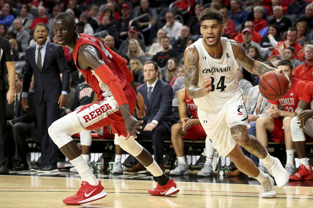 Cincinnati guard Jarron Cumberland (34) drives to the basket as UNLV forward Cheikh Mbacke Dion ...