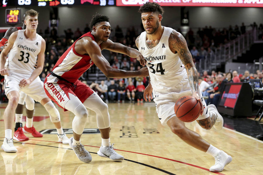 Cincinnati guard Jarron Cumberland (34) drives to the basket as UNLV guard Bryce Hamilton (13) ...