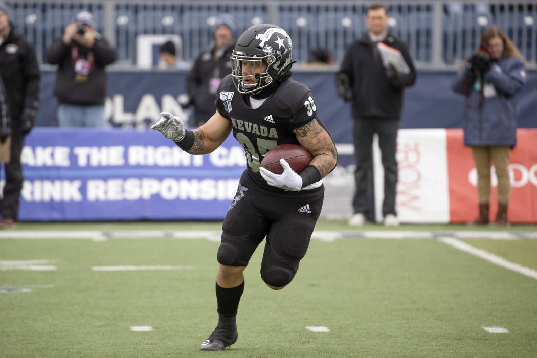 Nevada running back Toa Taua (35) runs against UNLV in the first half of an NCAA college footba ...