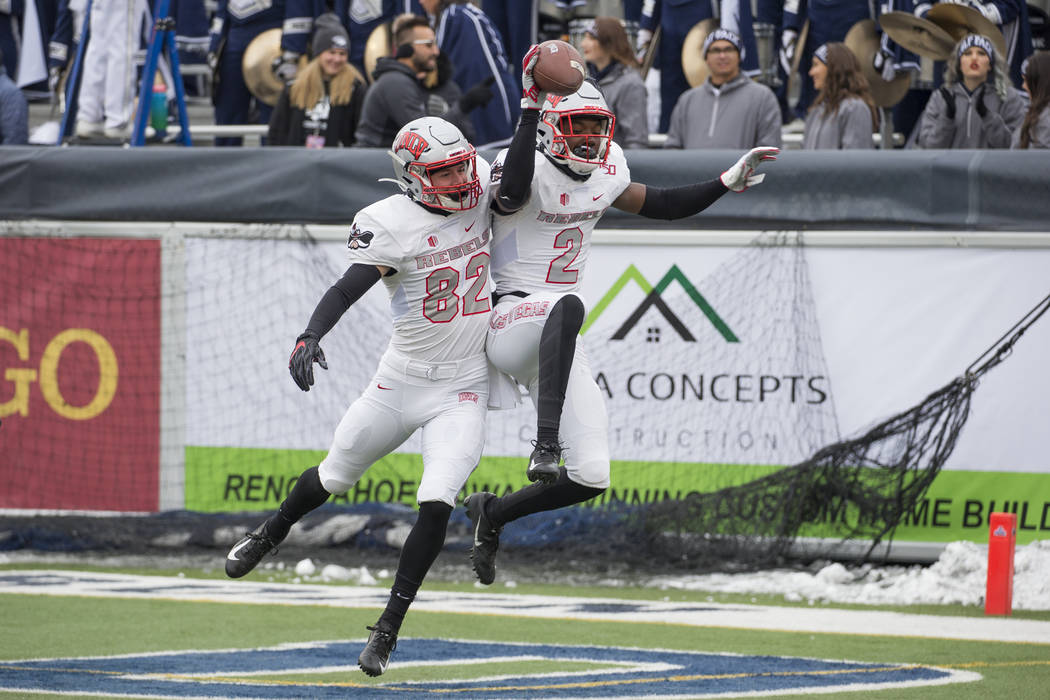 UNLV wide receiver Mekhi Stevenson (2) celebrates with teammate Jacob Gasser (82) after making ...