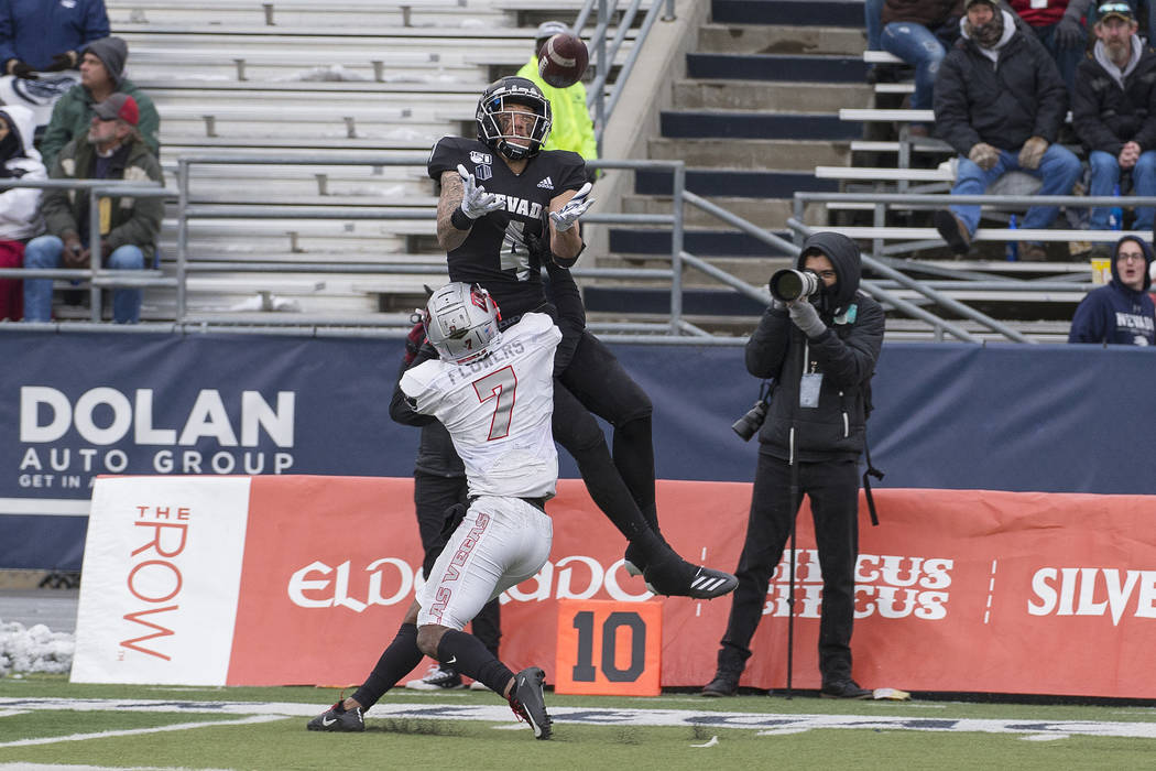 Nevada wide receiver wide receiver Elijah Cooks (4) goes up for a pass as UNLV defensive back J ...
