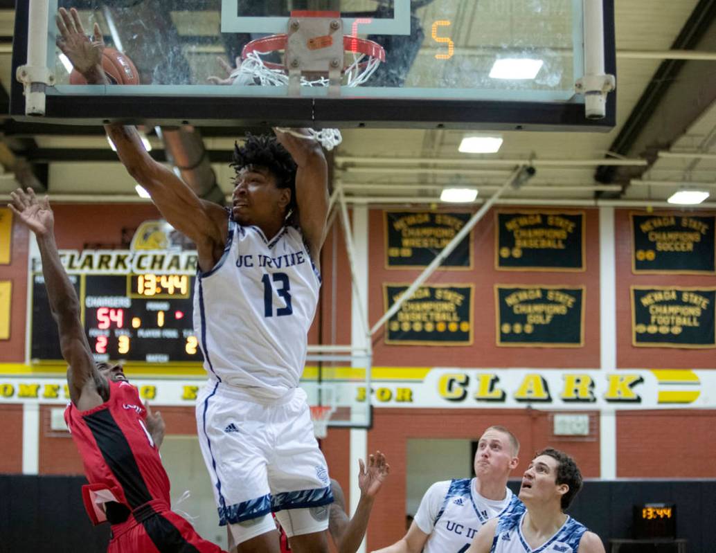 UC-Irvine's forward Austin Johnson (13) hits the backboard while trying to make a basket as Lou ...