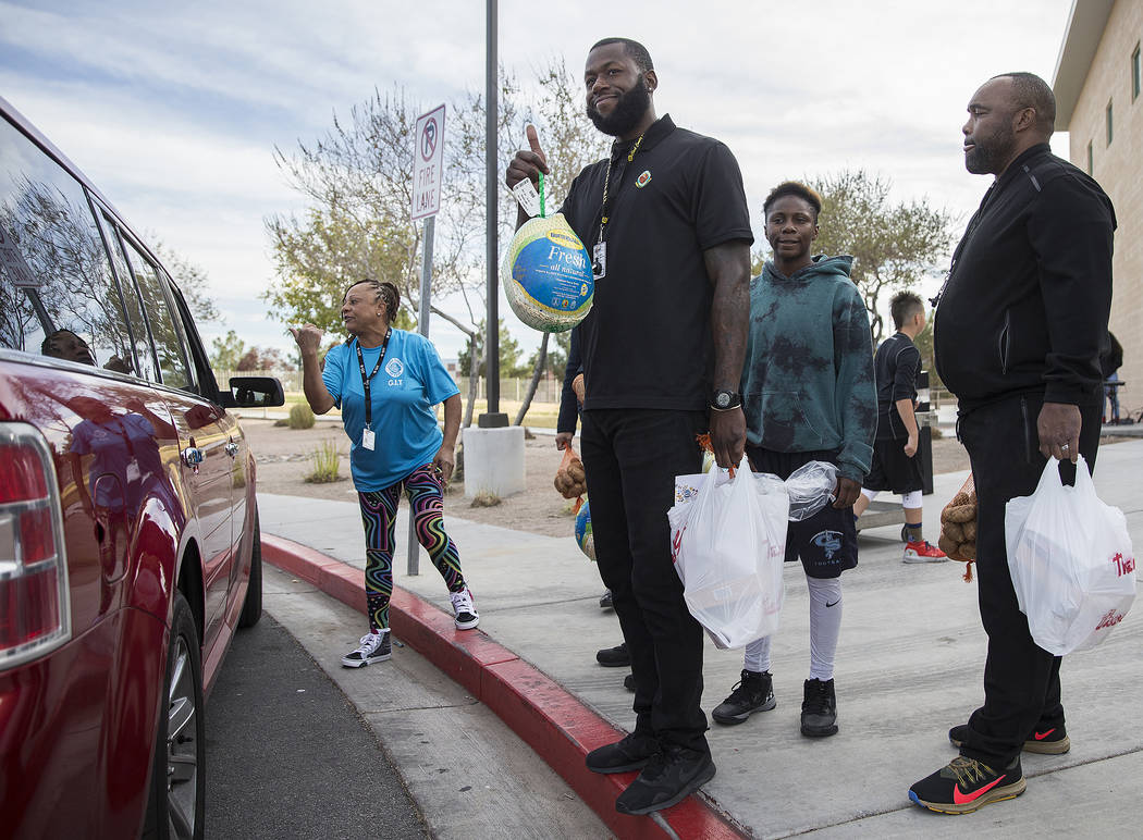 Gene Stokes, left, Luke James, Sincere Basped and Cedric Williams wait to load cars with Thanks ...