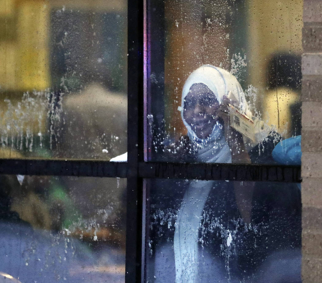A displaced resident looks out a window after a deadly fire at a high-rise apartment building W ...