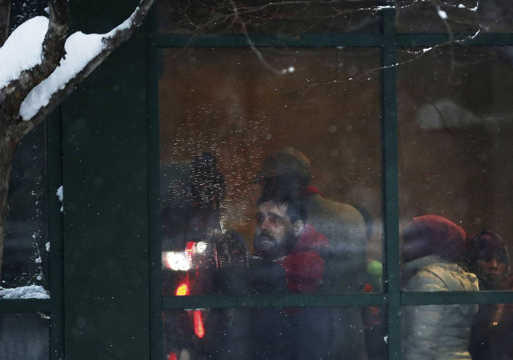 A displaced resident looks out a window after a deadly fire at a high-rise apartment building W ...