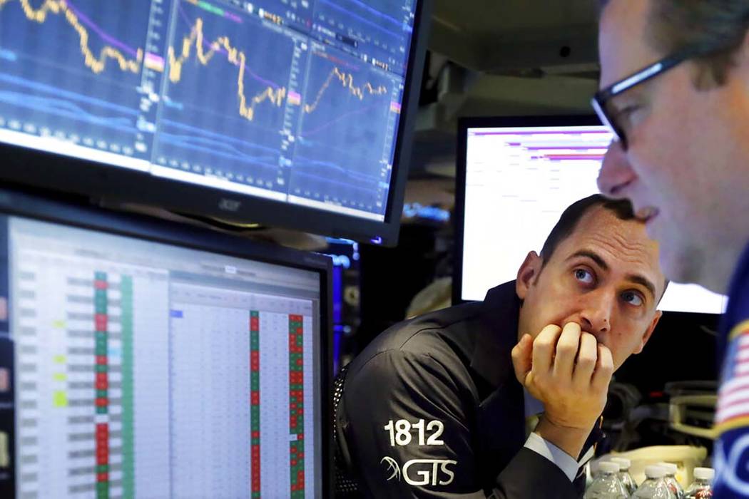 In a Nov. 14, 2019, file photo a pair of specialists work on the floor of the New York Stock Ex ...