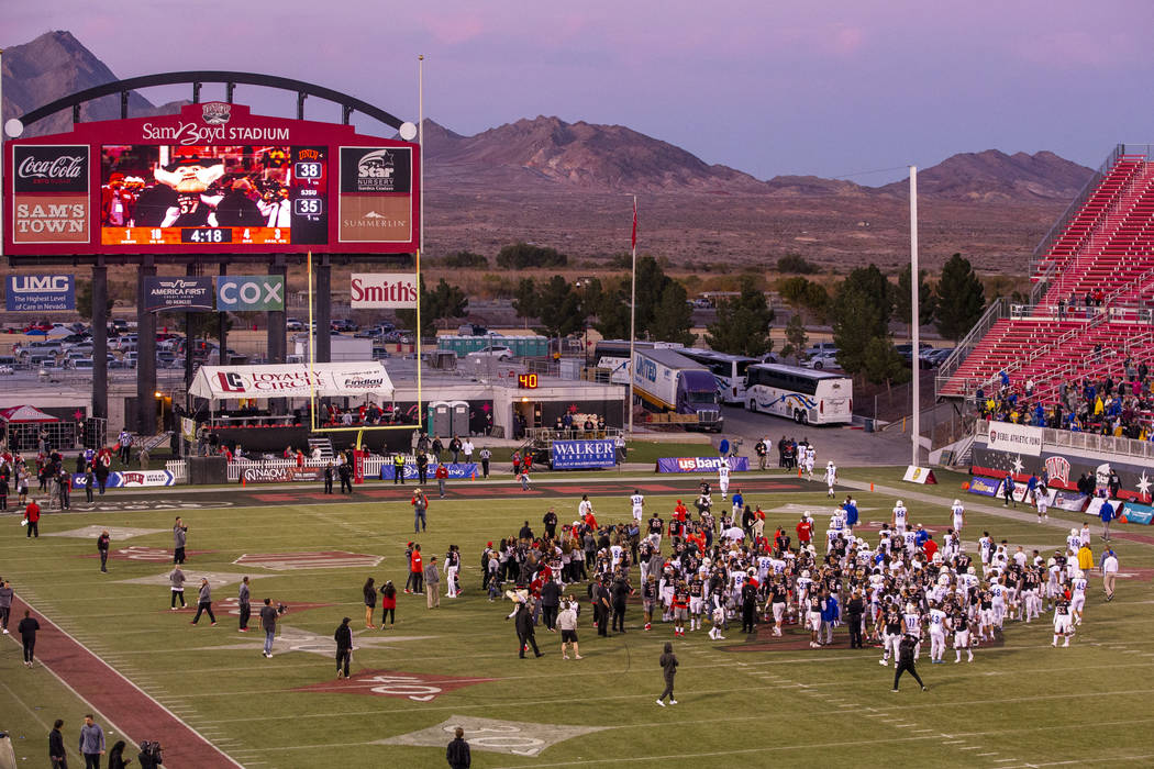 UNLV Rebels and San Jose State Spartans players and coaches come together on the field followin ...